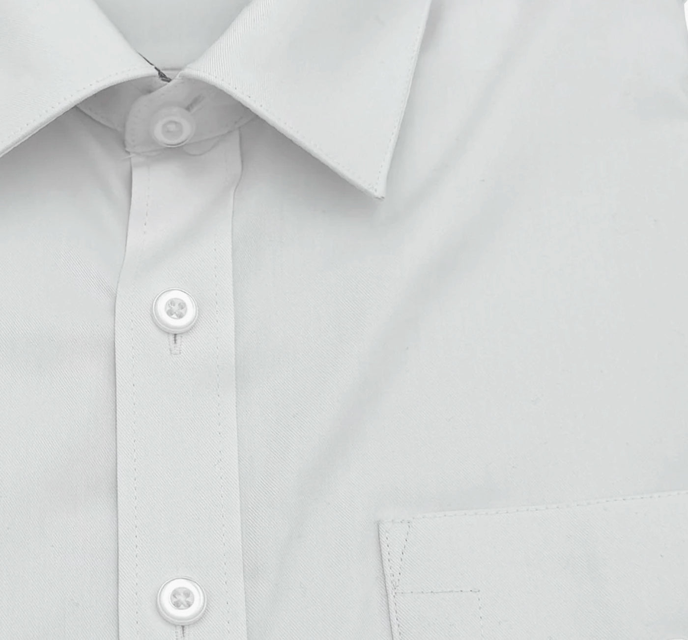 close up of the collar and buttons of a white pilot shirt.