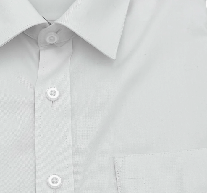 close up of the collar and buttons of a white pilot shirt.